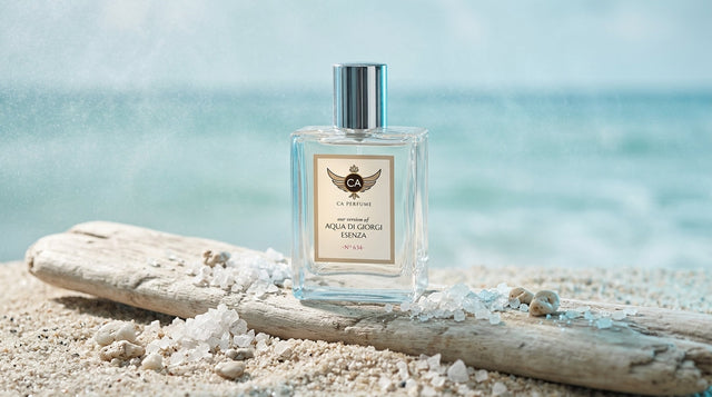 Marine cologne bottle on coastal rock with ocean waves in background