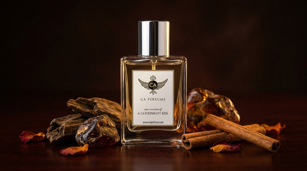 Amber floral perfume bottle surrounded by rose petals and amber resin on dark marble