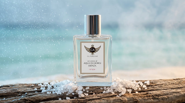 Marine scent perfume bottle beside sea salt and ocean mist on stone surface