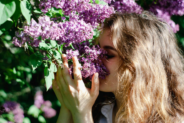 Woman experiencing mood lift from fragrance in natural light