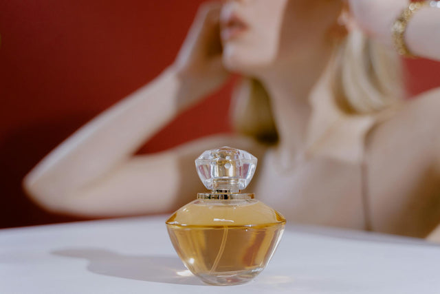 Woman holding a women eau de parfum bottle against soft light